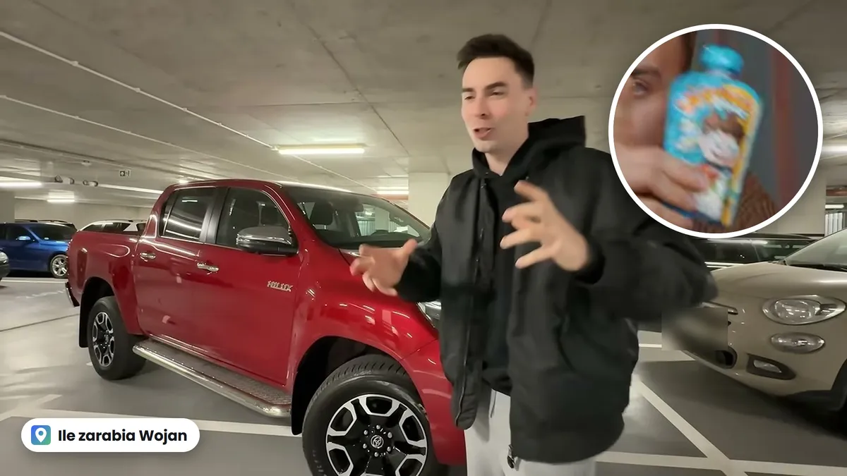 Wojan przy czerwonym samochodzie na podziemnym parkingu, w kółku mus Wojanek